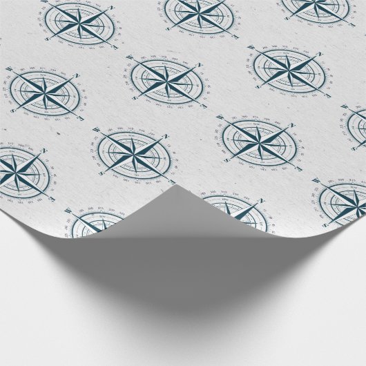 Nautisch kompas op getextureerde grijs cadeaupapier (Hoek)