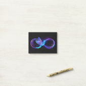 Neon Oneindigheidssymbool met Gloeiende Kolibrie Post-it® Notes (Op bureau)