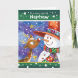 Nephew, Cute Reindeer en Snowman Feestdagen Kaart<br><div class="desc">Voor Nephew. Een schattige,  kleurrijke kerstkaart. De illustratie shows een zoet baby met grote open ogen en een leuke sneeuwman in een enorm pet die er goed uitziet,  neus aan neus,  aan elkaar. Ze zijn geplaatst tegen een blauwe waterverf hemel en de sneeuw valt om hen heen.</div>