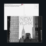 New York, USA Travel Postcard Briefkaart<br><div class="desc">Send this beautiful postcard to your loved ones featuring a vertical urban composition framing the Empire State Building and the New Yorker Hotel through a narrow gap between modern skyscrapers.</div>