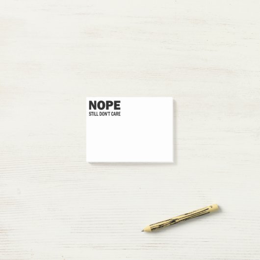 Nope geeft er nog steeds niets om post-it® notes (Op bureau)