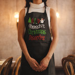 Obsessieve kerstziekte Funny Holiday Schort<br><div class="desc">OCD. Obsessieve kerstziekte,  zwart met groen,  rood en wit schrift. Een grappig kerstcadeau met een schattige kerstboom en kerstman om de woorden te versieren. Vakantiegeld humor cadeau.</div>