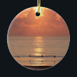 Ocean Sunrise Daytona Beach, Florida Ornament<br><div class="desc">Ornament met de ochtendzon die door zachte wolken op de oceaan breekt en een rij pelikanen; ©2014 Aaron Pate</div>
