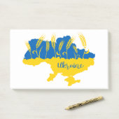 Oekraïense typografie en tarweoor onder Oekraïense Post-it® Notes (Op bureau)