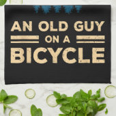 Onderschat nooit een oude man op een fiets. theedoek (Gevouwen)