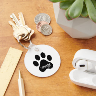 Ontwerp van silhouet van hondenpoot met naam sleutelhanger