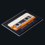Orange Retro Audiotape 70th birthday Guest Book Notitieboek<br><div class="desc">Old audio cassette to personalize with your name and date. Design on spiral notebook with text for 70th Birthday party guest book in horizontal guidance. You can easily change text (font, color, size and position) by clicking the customize button. Available in hard cover guest book. Matching birthday save the date...</div>