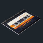 Orange Retro Audiotape 70th birthday Guest Book Notitieboek<br><div class="desc">Old audio cassette to personalize with your name and date. Design on spiral notebook with text for 70th Birthday party guest book in horizontal guidance. You can easily change text (font, color, size and position) by clicking the customize button. Available in hard cover guest book. Matching birthday save the date...</div>