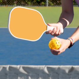 Oranje achtergrondstructuur gedempt voor web en af pickleball paddle