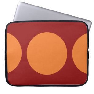 Oranje cirkels op rood laptop sleeve