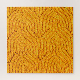 Oranje gebreide trui, gestructureerde achtergrond. legpuzzel