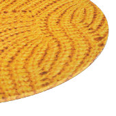 Oranje gebreide trui, gestructureerde achtergrond. snijplank (Hoek)