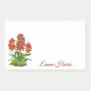 Oranje rode orchidee bloem na het opschrift post-it® notes