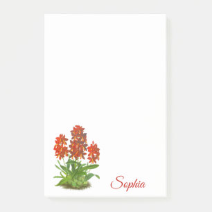 Oranje rode orchidee bloem na het opschrift post-it® notes