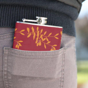 Oranje silhouetbladeren op rood heupfles