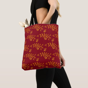 Oranje silhouetbladeren op rood tote bag