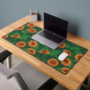 Oranje Zinnia bloemen, groene bladeren op donkergr Bureaumat
