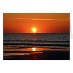 Oranje zonsopgang op het strand