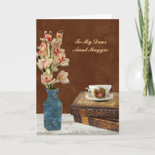 Orchideeënboeket met boeken en kopje verjaardag kaart