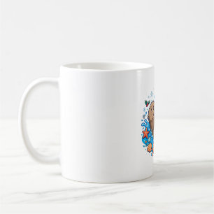 Otter houdt kerstornament vast koffiemok