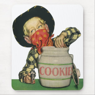Oude cowboy-speelgoedpistool hand in de koektromme muismat