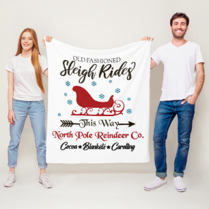 Oude, gevlekte slee met kersttang fleece deken