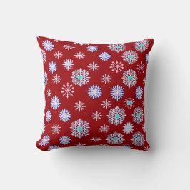 Oude sneeuwvlokken op rood kussen