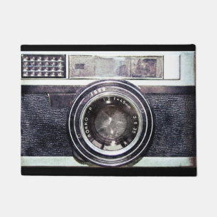 Oude zwarte camera deurmat