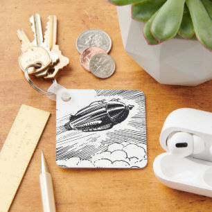 Ouderwetse sciencefiction-ruimteschipraket in wolk sleutelhanger