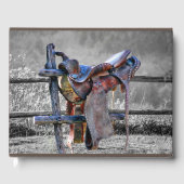 Paardenzadels op korraalhek Western Gastenboek (Voorkant)