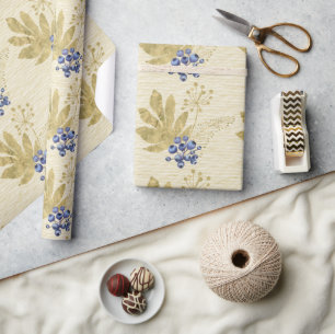 Paarse bessen en gouden bladeren op lichtgeel cadeaupapier