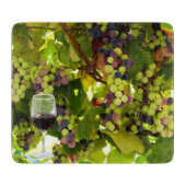 Paarse druiven die op de wijnstok met wijnglas gro snijplank (Voorkant)