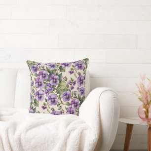 Paarse viooltjes op wit kussen