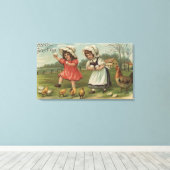 PaasgroetKleine meisjes die eieren houden Canvas Afdruk (Insitu (Houten vloer))