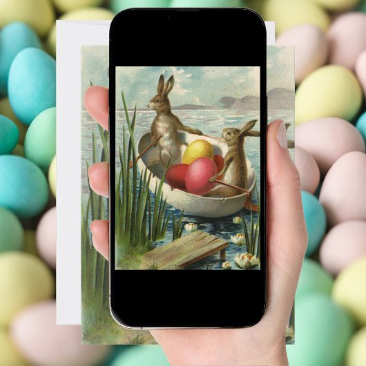 paaskonijntjes in een boot met paaseieren feestdagenkaart