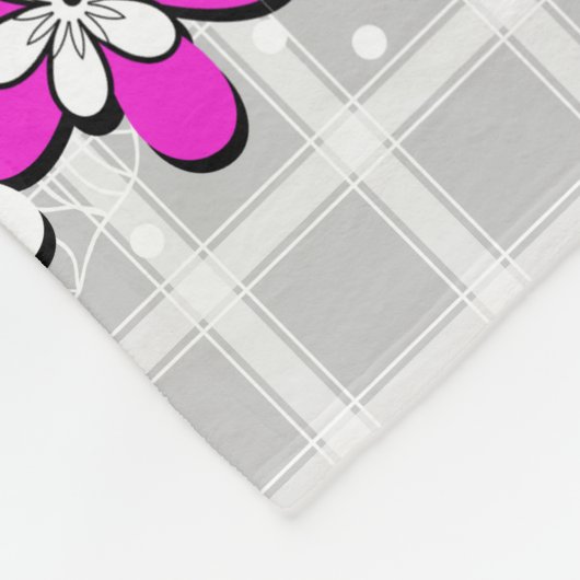 Papierneonbloemen op een grijs-witte geraffineerde fleece deken (Hoek)