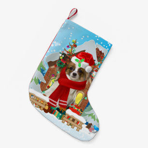 Papillon-hond met kerstcadeaus kleine kerstsok