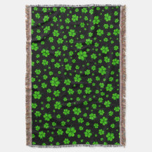 Pattern of green shamrocks on black background