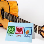 Peace Love Guitar Feestdagen Kaart<br><div class="desc">Een coole gitarist kerstkaart met een vredesbord,  hart en gitaar op een mooie blauwe achtergrond. Een schattige muzikaal instrument slaat een vakantiekaart op die de Peace Love Guitar leest.</div>