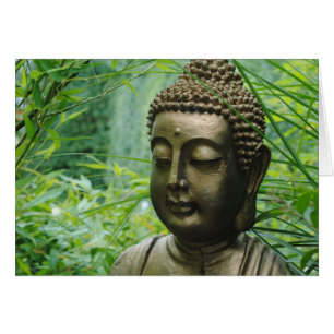 Peaceful Buddha Statue in a Leafy Green Forest