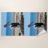 Pelikaan neergestreken op een strandrots, strandlaken (Voorkant)