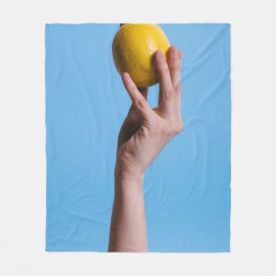 Person holding lemon fleece deken