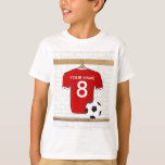 Personaliseerbaar Rood Wit Voetbalshirt T-shirt<br><div class="desc">Een gepersonaliseerde football voetbaltruc in het rood met witte sierstrip, in een sportkleedkamer met een waterfles, een football en een voetbal. Voeg alleen de naam en het nummer (of leeftijd) van de voetbalspeler, de football fan of de voetbalcoach toe aan de creëer van een uniek voetbalcadeau. Andere kleuren van het...</div>