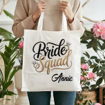 Personalized Gold Bride Squad Bachelorette Party Tote Bag<br><div class="desc">Get ready for the ultimate girls' getaway with this chic Bride Squad tote bag! Featuring elegant gold-toned typography and sparkling diamond accents, this bag is the perfect accessory for bachelorette weekends, bridal showers, or as a stylish wedding welcome bag. Durable and spacious, it's designed to hold all your party essentials...</div>