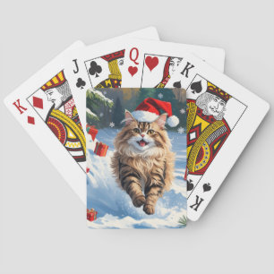 Perzische kat zit in de sneeuw met kerstmuts pokerkaarten