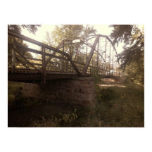 Photograph of an old, rusty iron truss bridge