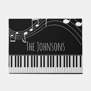 Pianotoetsenbord en muzieknotities deurmat
