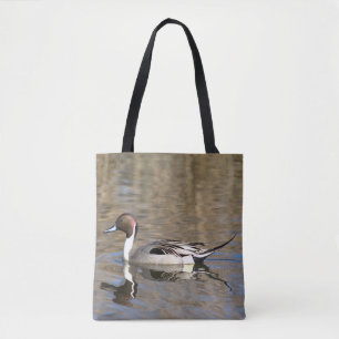 Pijlstaart eend zwemt in een vijver tote bag