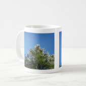 Pijnboom met sneeuwklemmen op blauwe hemel koffiemok (Voorkant links)