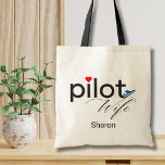 Pilot Wife Script Heart Airplane Simple Custom Tote Bag<br><div class="desc">The word "Pilot" is designed with a cute tiny red heart image above the letter "i" and a fun blue airplane at the end of word "Pilot". The word 'Wife' is in a script calligraphy font right below the word Pilot. Personalize your name in this simple, minimalist design for a...</div>
